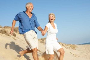 Senior Couple Walking On The Beach